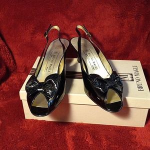 Bruno Magli black patent open toed slingback with snakeskin bow. Made in Italy.